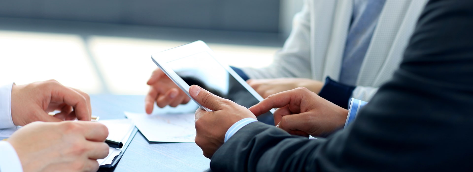 Business team reviewing a mobile app on a tablet during a planning meeting